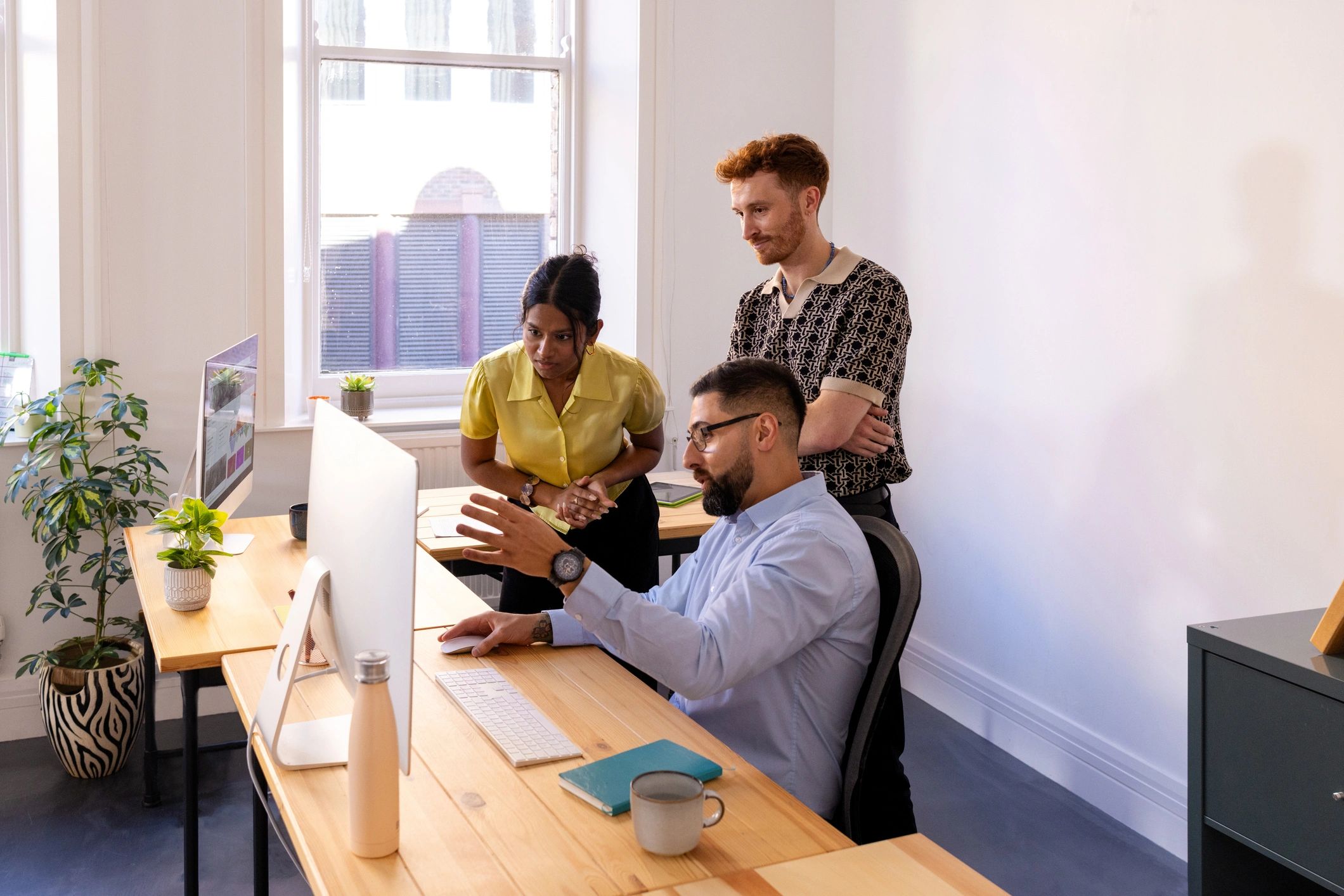 Startup support team reviewing work on a laptop